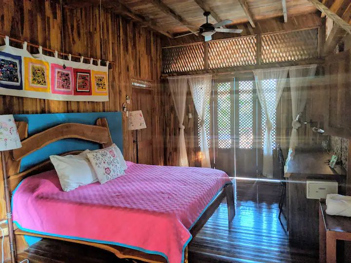 Colored tropical bedroom at Casa KUPU KUPU luxury home for sale samara Guanacaste Costa Rica