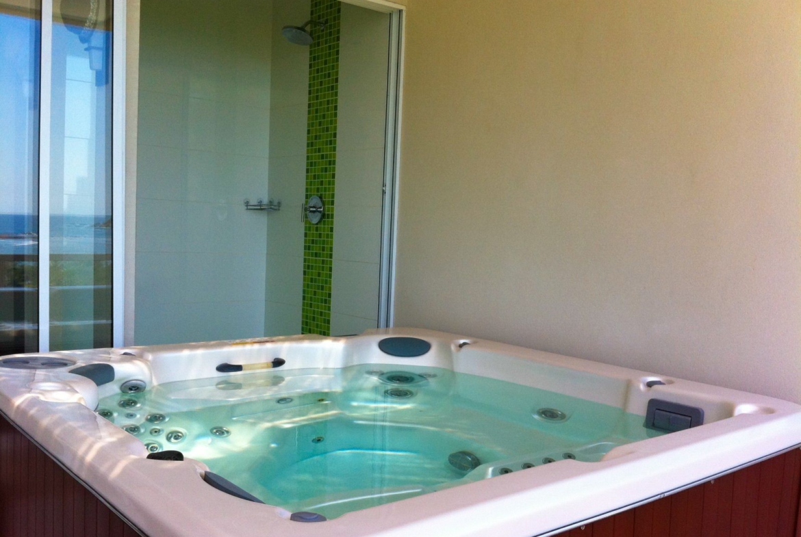 square jacuzzi with blue water shower at the back Samara Reef Condo for sale Samara Guanacaste Costa Rica