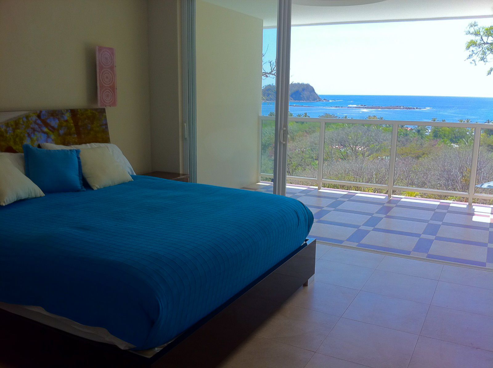 Queen sized bed with balcony overlooking the ocean Samara reef Condo for sale Samara Guanacaste Costa Rica