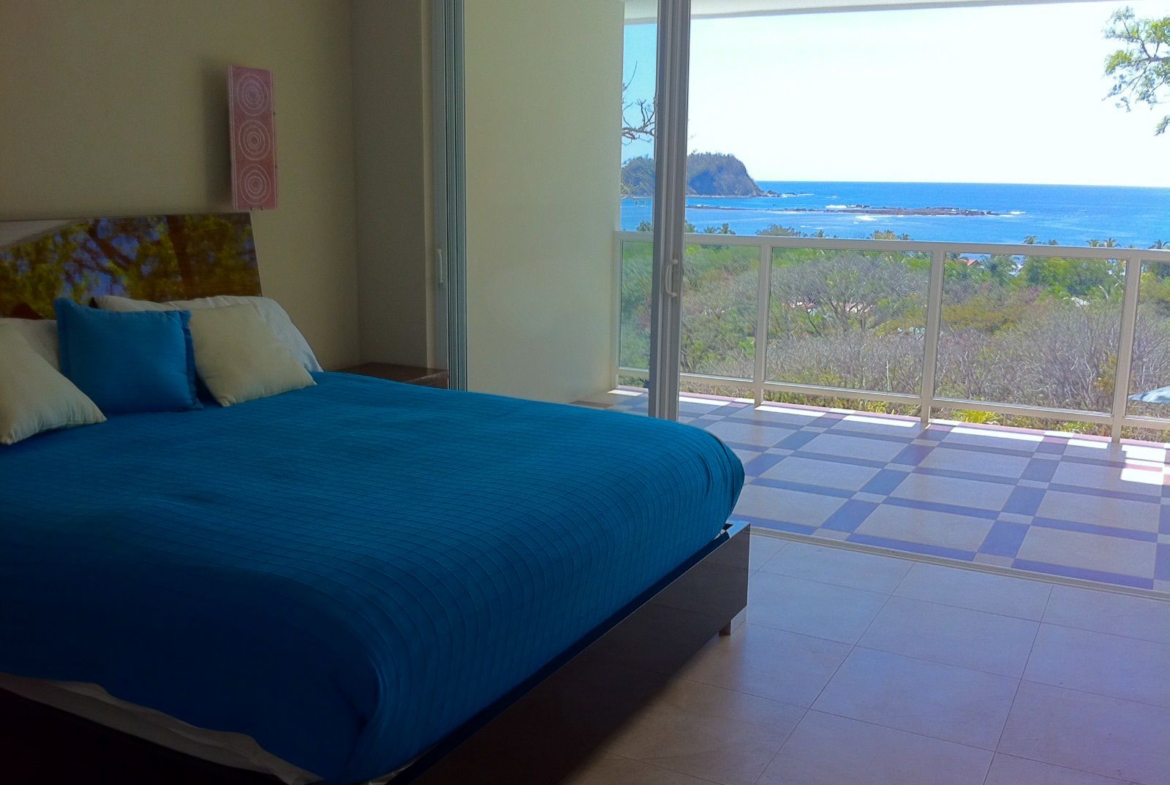 Blue bed with pillows ocean Samara Reef Condos luxury home real estate for sale samara Guanacaste Costa Rica