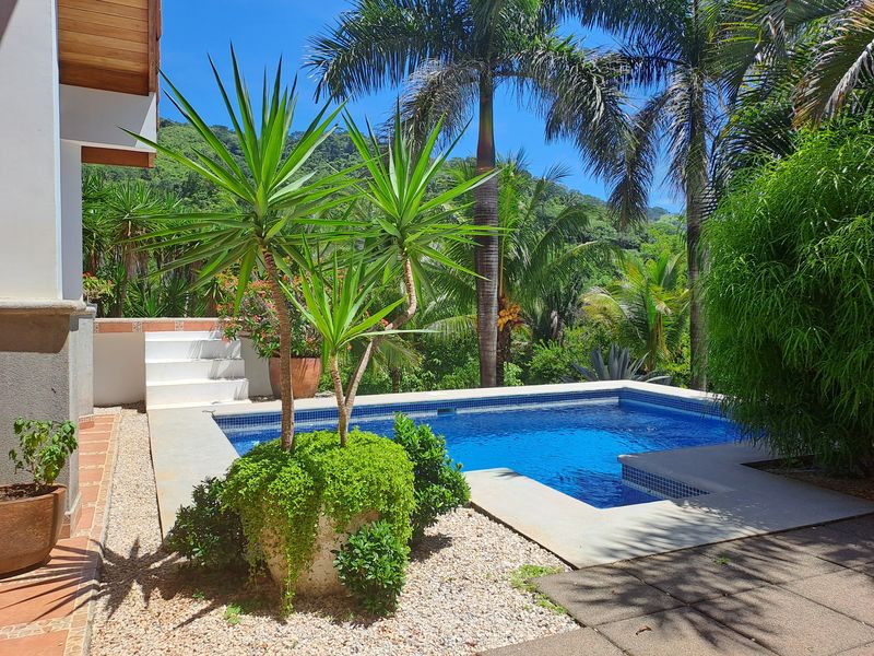 Blue swimming pool with yoga deck at Casa Vista Las Palmas home for sale samara guanacaste costa rica