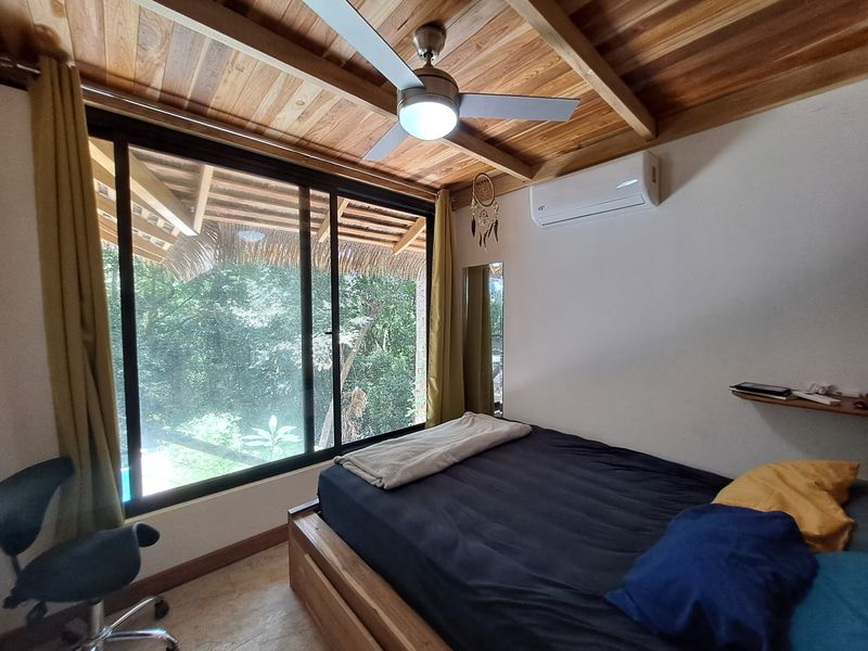 bedroom with windows open on the jungle at Casa Jungle Oasis home for sale Samara Woods Samara Costa Rica