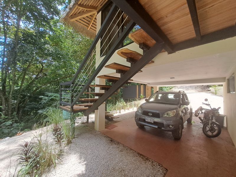 carport with car and moto at Casa Jungle Oasis home for sale Samara Woods Samara Costa Rica
