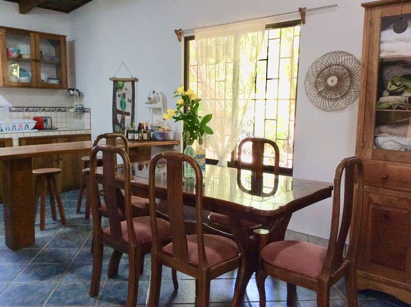 Wooden table and chairs in livingroom of Casa Surfside home for sale Samara Guanacaste Costa Rica