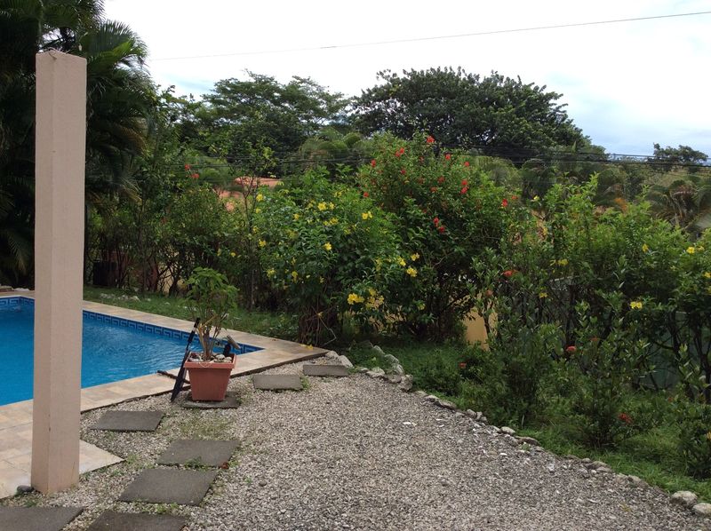 blooming flowers around the pool of Casa Surfside home for sale Samara Guanacaste Costa Rica